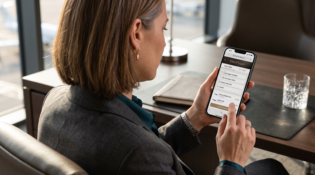 Traveler booking a private jet flight on a smartphone using an online charter platform